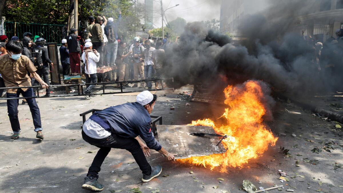 Protesters and police clash Wednesday in Jakarta after the announcement of election results.