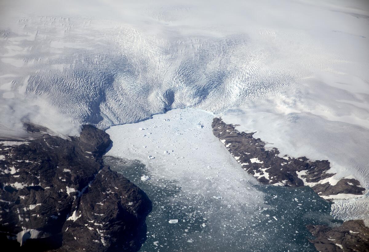 A glacier calves icebergs into a fjord in southeastern Greenland in 2017.