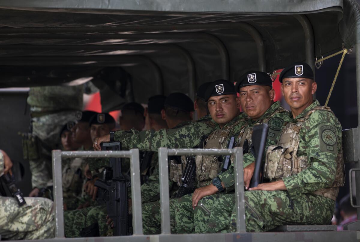 Troops sit in an airplane.