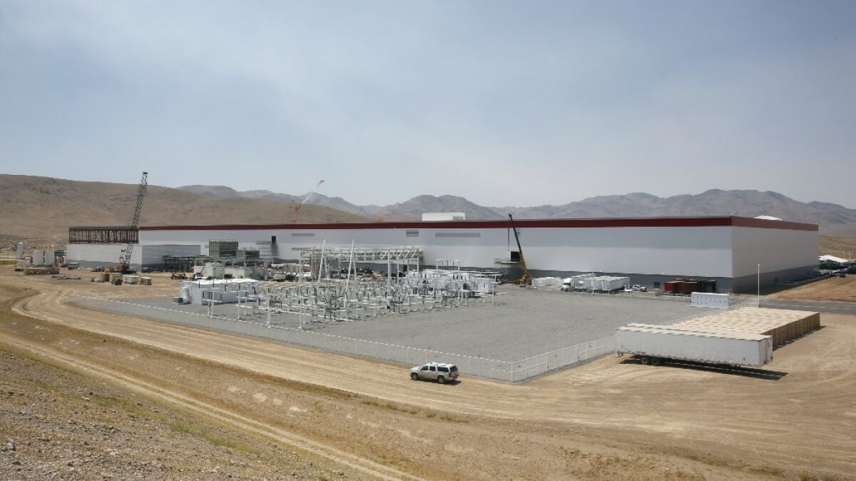 The $5-billion Tesla Gigafactory in Sparks, Nev., began the mass production of lithium-ion battery cells on Wednesday.