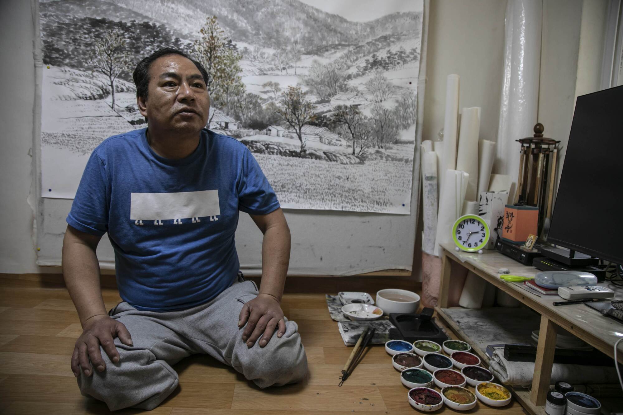 Mr. Yoon Yong-ju, representative of the neighborhood community center in Jjokbangchon in Dongja-dong, sits in his room