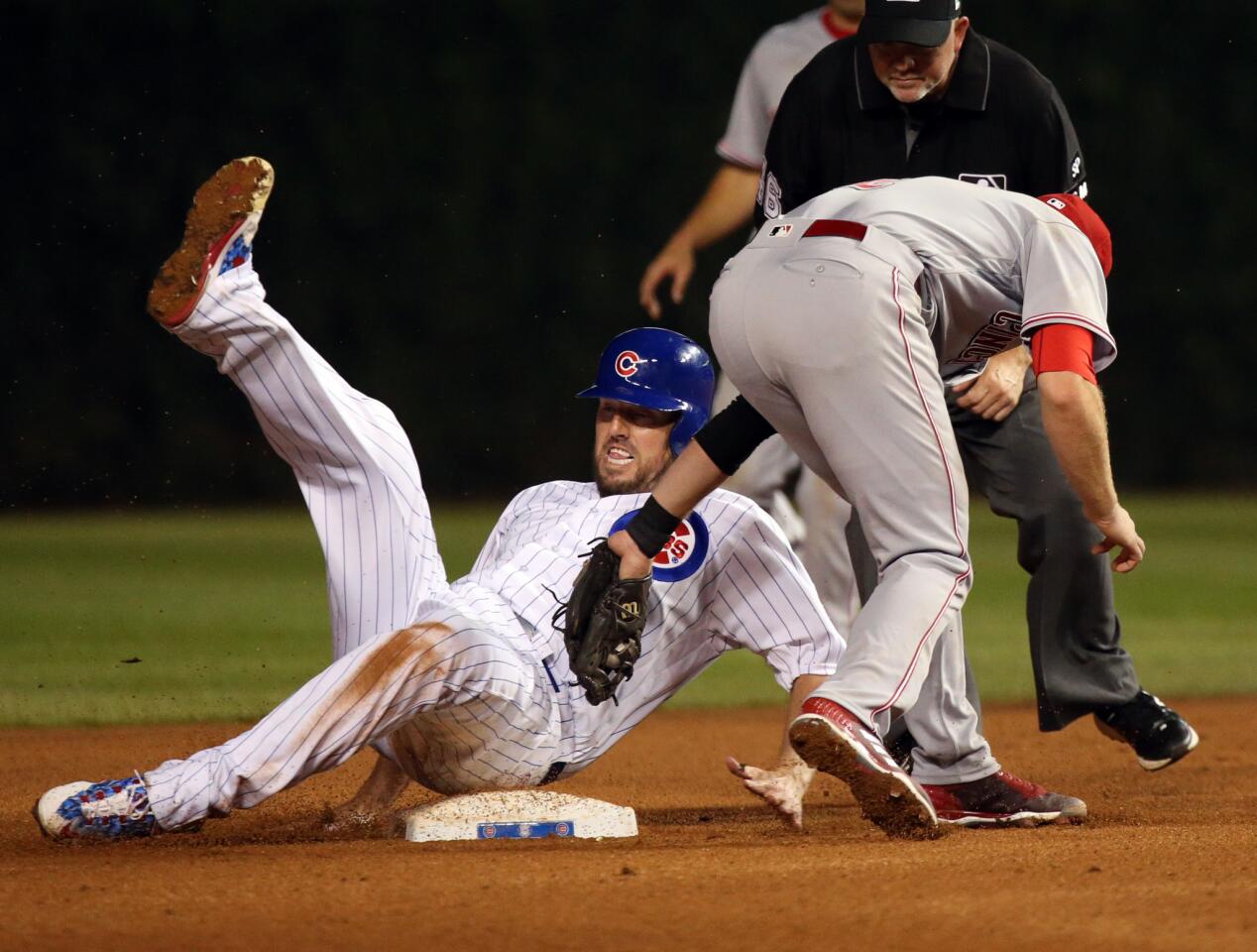 Cubs starting pitcher John Lackey steals second base in front of Reds shortstop Zack Cozart during the fourth inning at Wrigley Field on Wednesday, Aug. 16, 2017.
