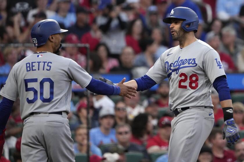 Dodgers' J.D. Martinez, right, is congratulated by Mookie Betts after hitting a home run on May 20, 2023, in St. Louis.