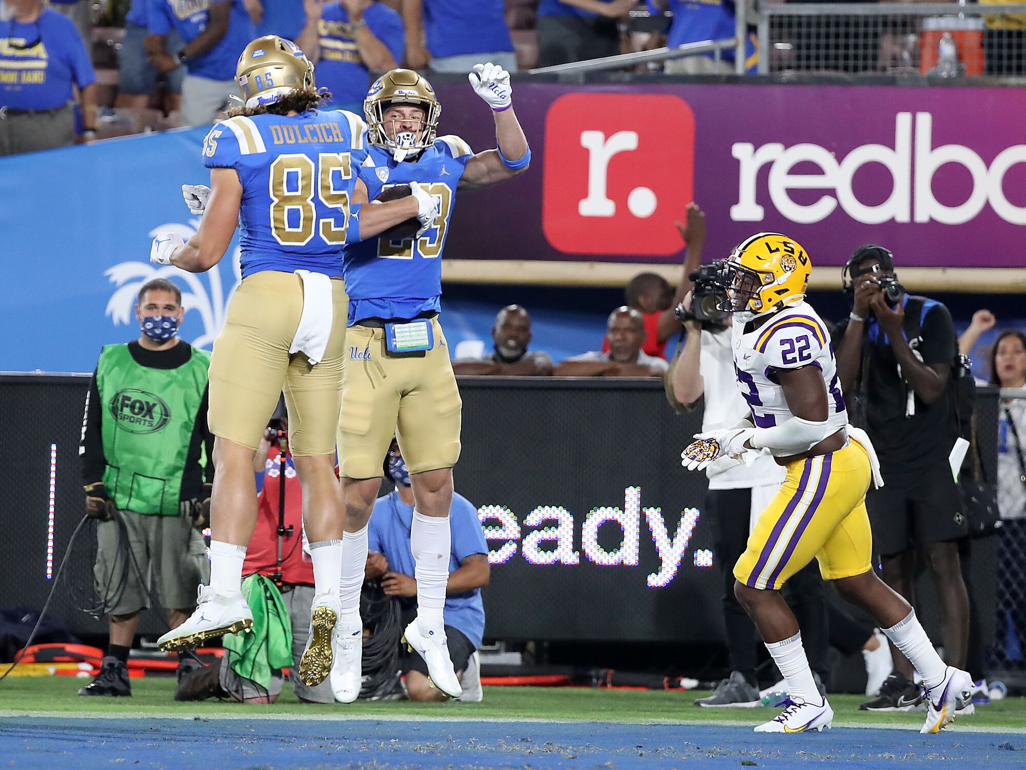  UCLA wide receiver Chase Cota (23) is congratulated by teammate Greg Dulcich.