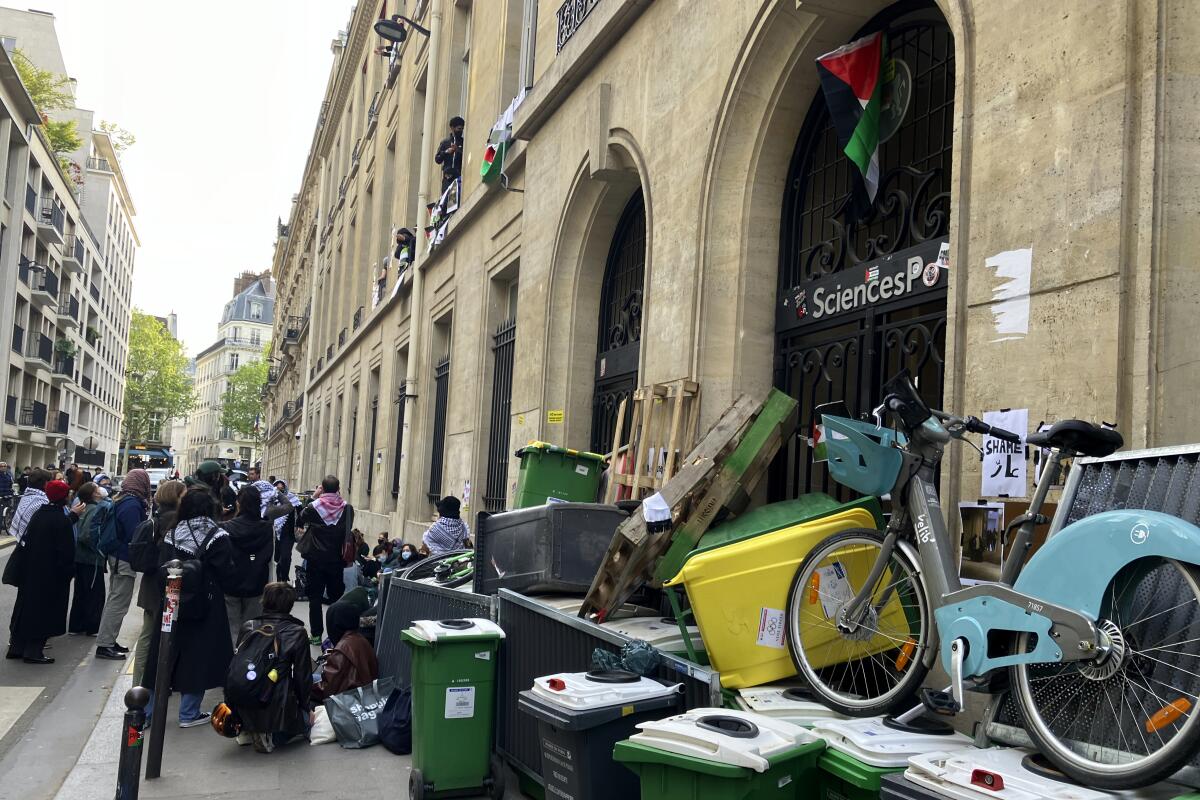 Students at a Paris university piled trash bins and bicycles on a street to block access to a campus building.
