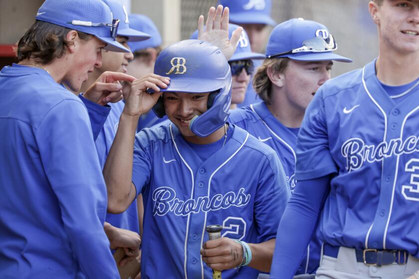 SAN DIEGO, CA - MARCH 28, 2024: Rancho Bernardo's Hugo Gonzalez is congratulated by teammates after scoring in the sixth inning of the Lions Tournament Open Division final against Cathedral Catholic at Cathedral Catholic High School in San Diego on Thursday, March 28, 2024. (Hayne Palmour IV / For The San Diego Union-Tribune)