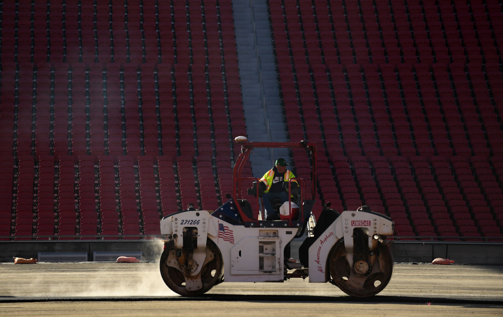 Work crews begin paving the track at the Coliseum in preparation for a NASCAR race.