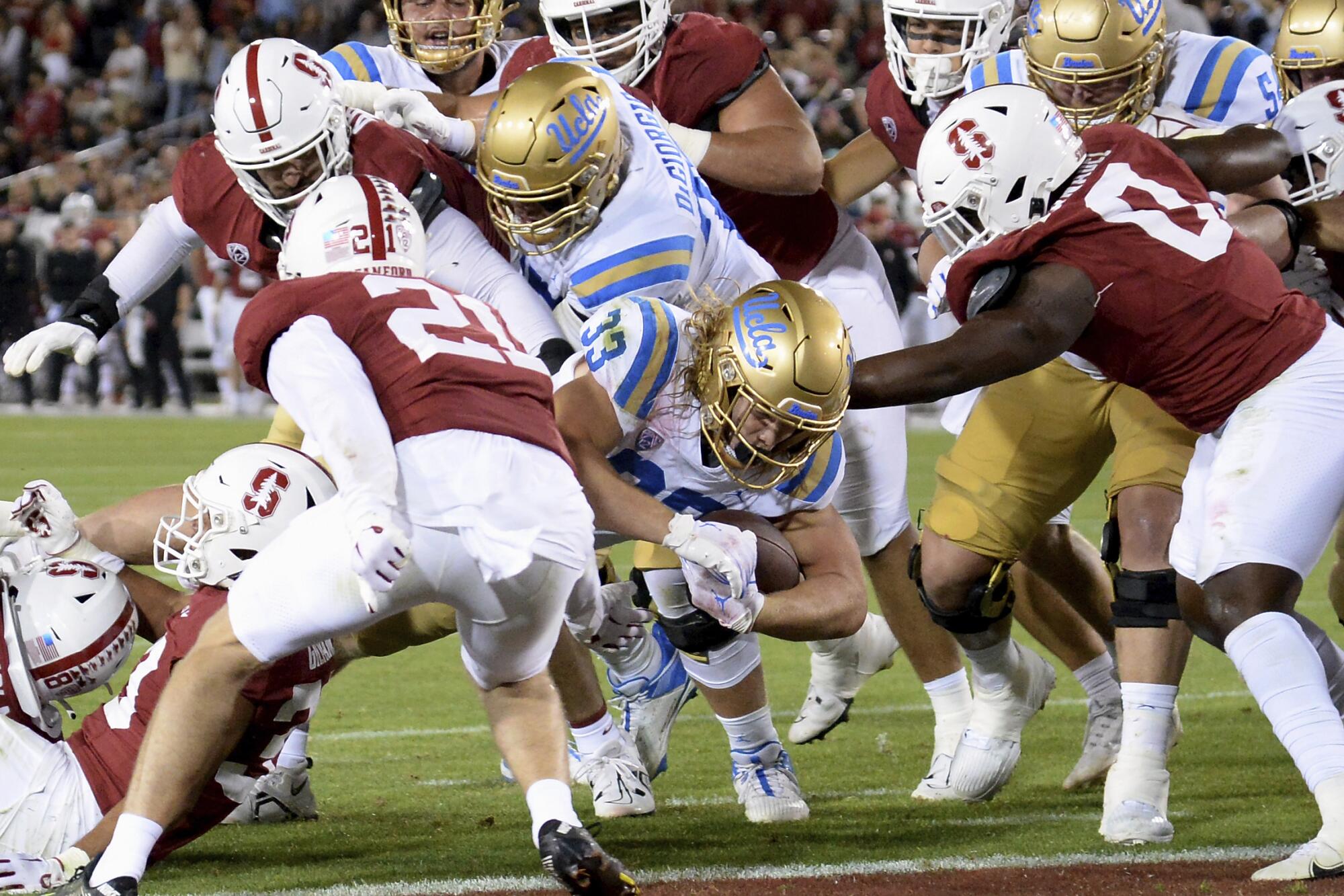 UCLA running back Carson Steele (33) scores a touchdown during an NCAA college football game.