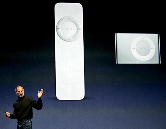 Jobs announces a new iPod Shuffle, right, and compares it to the the older Shuffle, left. He also announced a new iPod nano with a 24-hour battery life and new games for the portable media player.