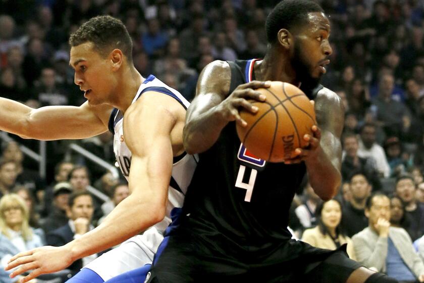 Los Angeles Clippers forward JaMychal Green, right, steals the ball from Dallas Mavericks forward Dwight Powell, left, during the first half of an NBA basketball game in Los Angeles, Monday, Feb. 25, 2019. (AP Photo/Alex Gallardo)