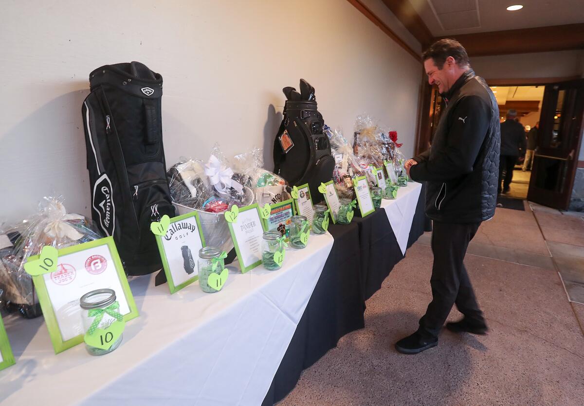A guest participates in the silent auction during the Bradley Rofer Foundation Golf Tournament.