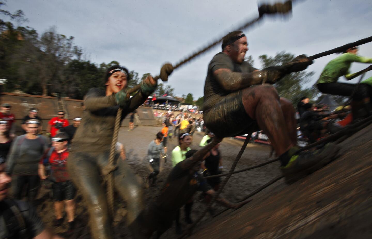 Participants use ropes to climb up the "slip wall" obstacle during the Reebok Spartan Race at Calamigos Ranch in Malibu on Dec. 7, 2014.
