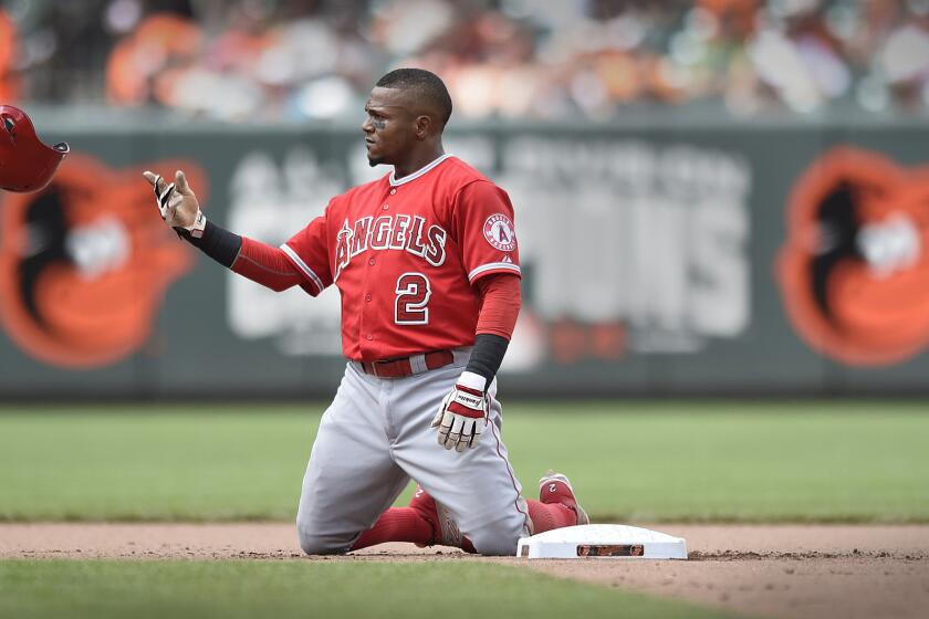 Angels shortstop Erick Aybar tosses his helmet after getting tagged out during a double play in the seventh inning Sunday in Baltimore.