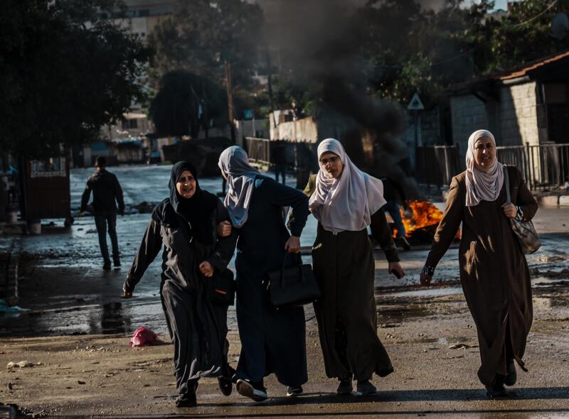 Women walk down a street in Jenin in the occupied West Bank.