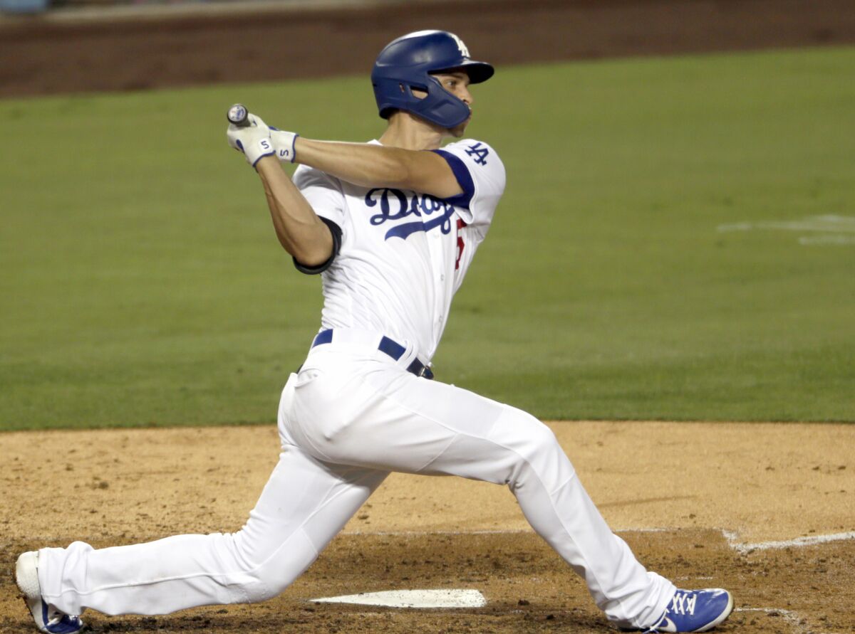 The Dodgers' Corey Seager follows through on a two-run double against the Colorado Rockies on Aug. 21, 2020.