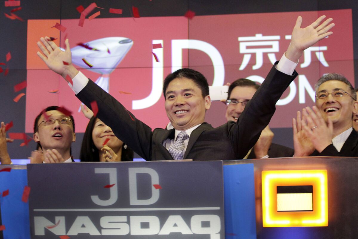 FILE - Liu Qiangdong, also known as Richard Liu, CEO of JD.com, raises his arms to celebrate the IPO for his company at the Nasdaq MarketSite, in New York on May 22, 2014. Chinese e-commerce company JD.com said Thursday, April 7, 2022, that its founder Richard Liu has left his position as CEO, the latest Chinese billionaire tech company founder to step aside amid increased government scrutiny of the country’s technology industry.(AP Photo/Mark Lennihan, File)