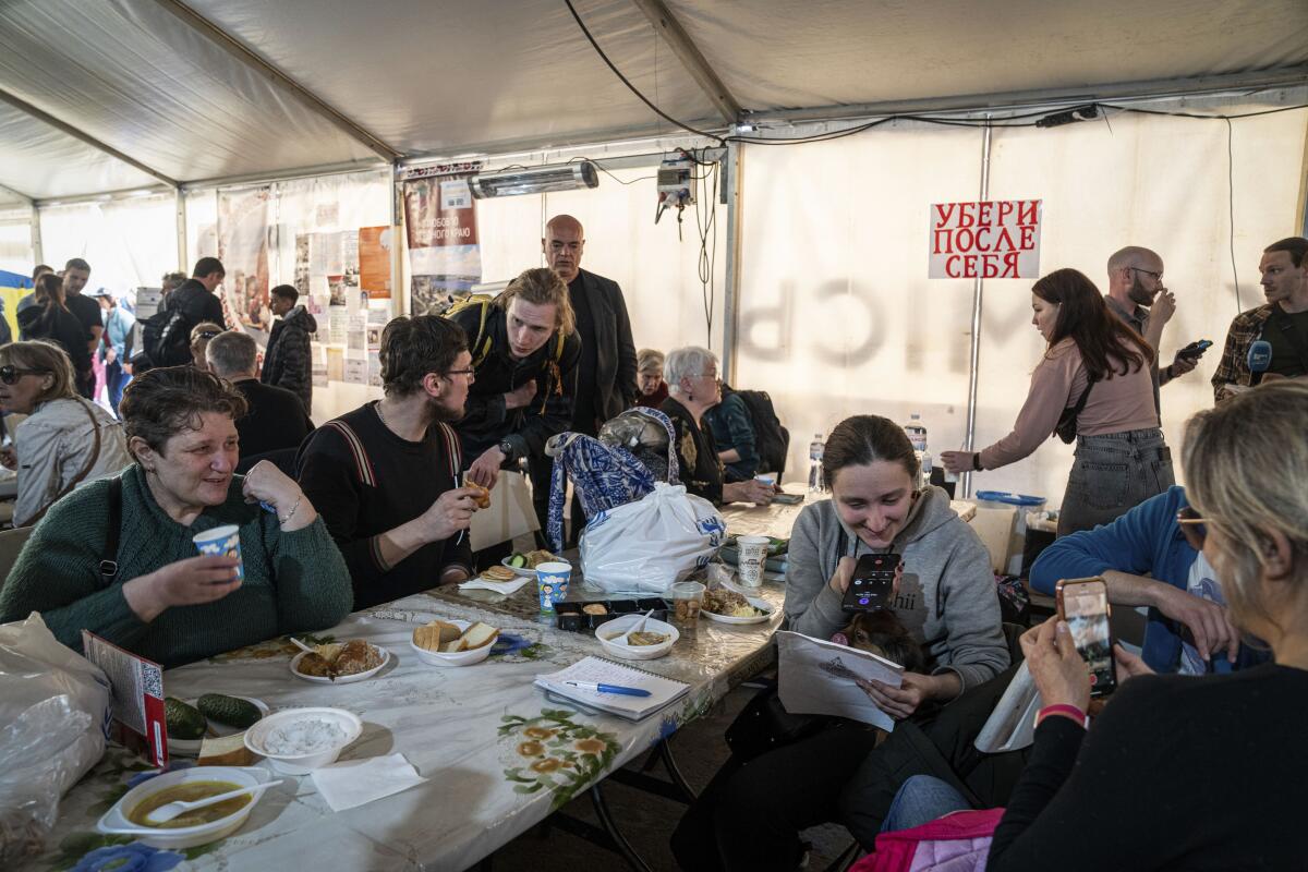 People having a meal at a center for displaced people in Zaporizhzhia, Ukraine