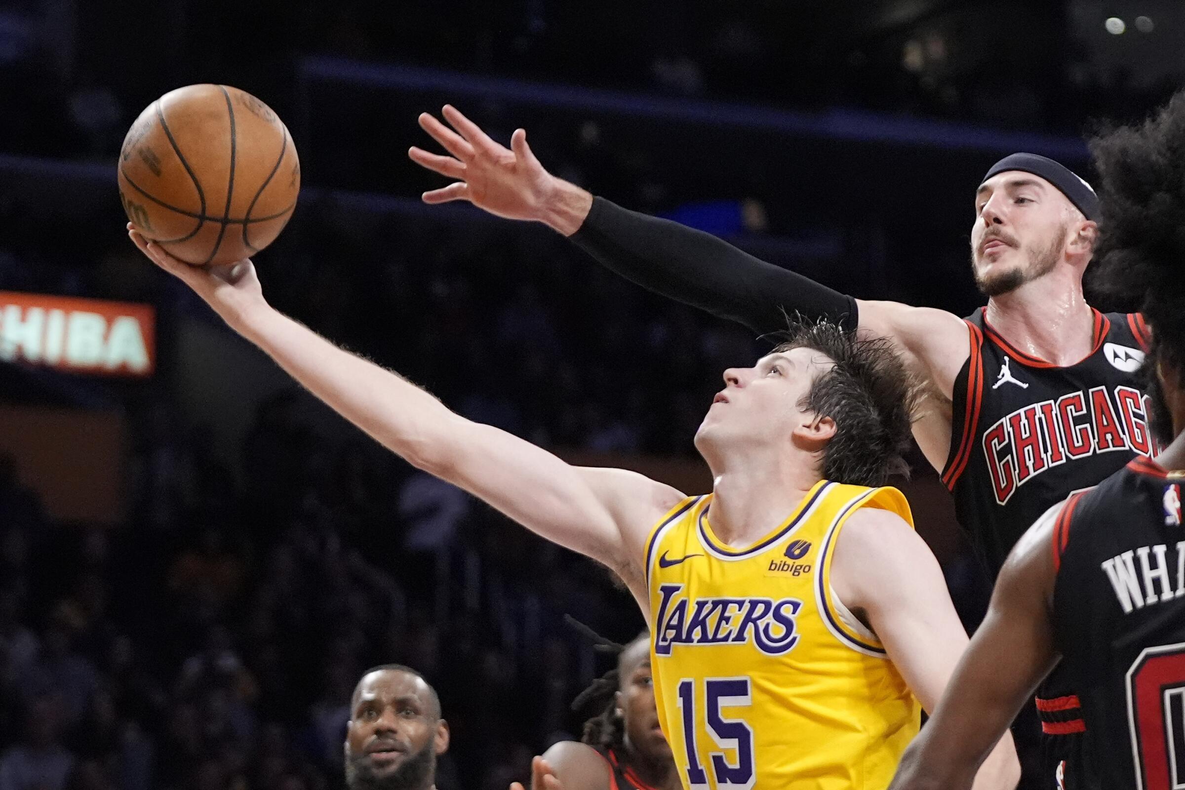 Lakers guard Austin Reaves drives past Bulls guard Alex Caruso defends during Thursday's game.