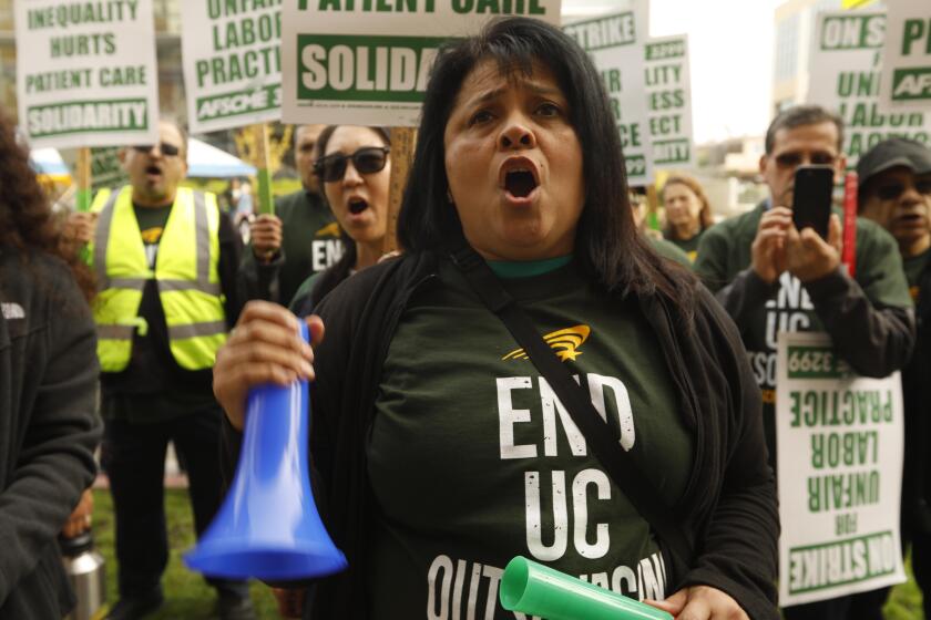 SANTA MONICA, CA - NOVEMBER 13, 2019 - - Maria Torres, a Certified Surgical Technologist, joins other University of California healthcare and service workers, represented by AFSCME 3299, who picket in front of the Santa Monica UCLA Medical Center and Orthopaedic Hospital during a one-day strike accusing UC of unfair labor practices through unlawful outsourcing of jobs in Santa Monica on November 13, 2019. (Genaro Molina / Los Angeles Times)