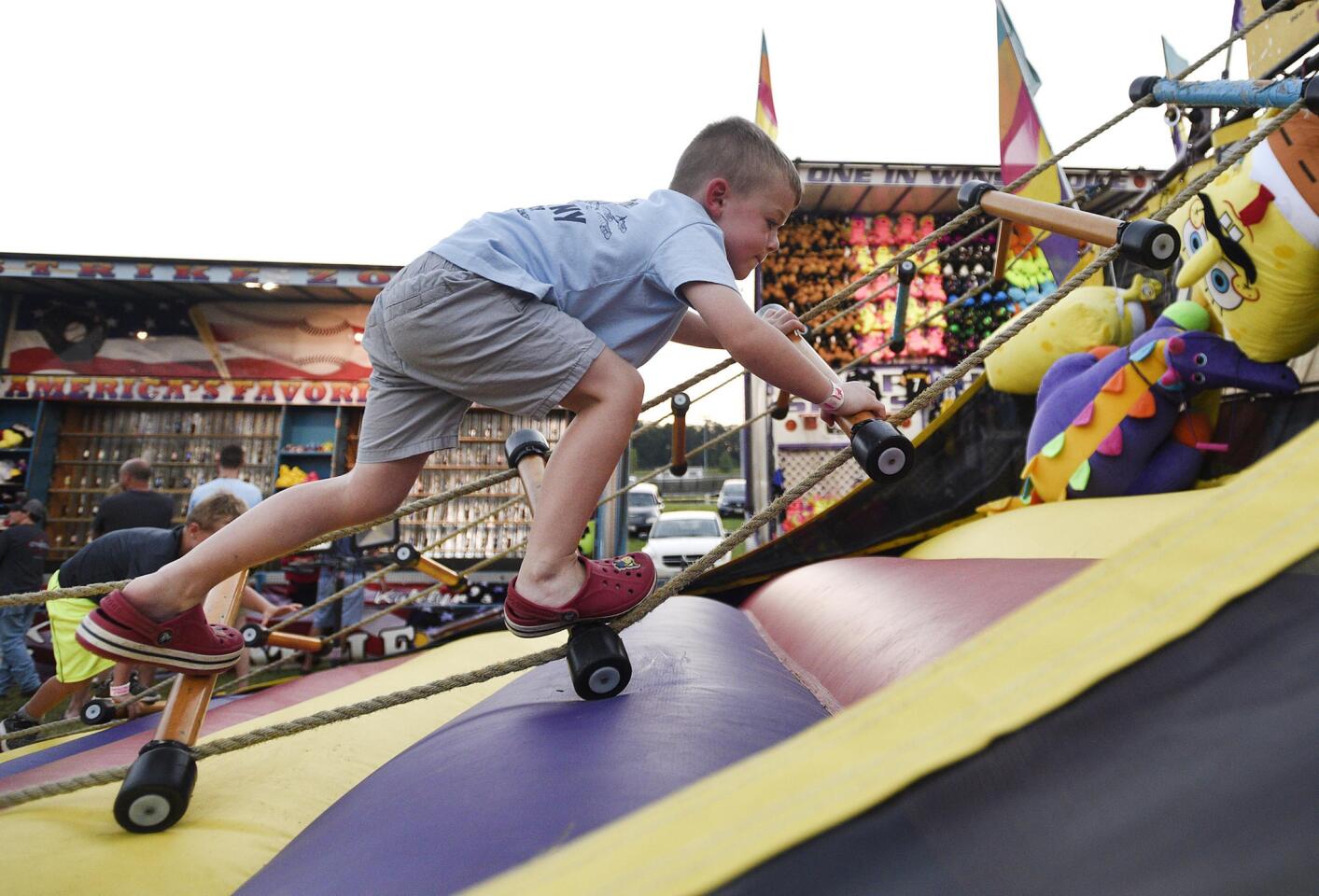 Brady Dunn, 5, of Eldersburg, tries the Ladder Climb on the midway of the the Winfield fire company carnival Wednesday, July 10, 2019.