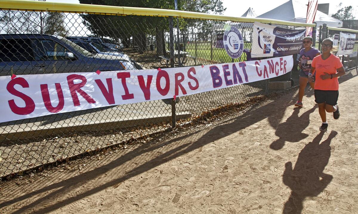 In this Oct. 2914 photo, runners participate in the 24-hour Relay for Life event at Scholl Canyon Park in Glendale. More than 35 teams made up of a total of 800 people are expected to walk around the field nonstop this year to raise money for the American Cancer Society.