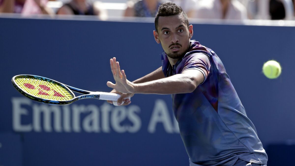 Nick Kyrgios returns a shot from John Millman during their first-round match Wednesday.