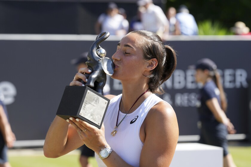 France's Caroline Garcia kisses the winner's trophy after the women's final of the WTA tour in Bad Homburg, Germany, Saturday, June 25, 2022. (Thomas Frey/dpa via AP)