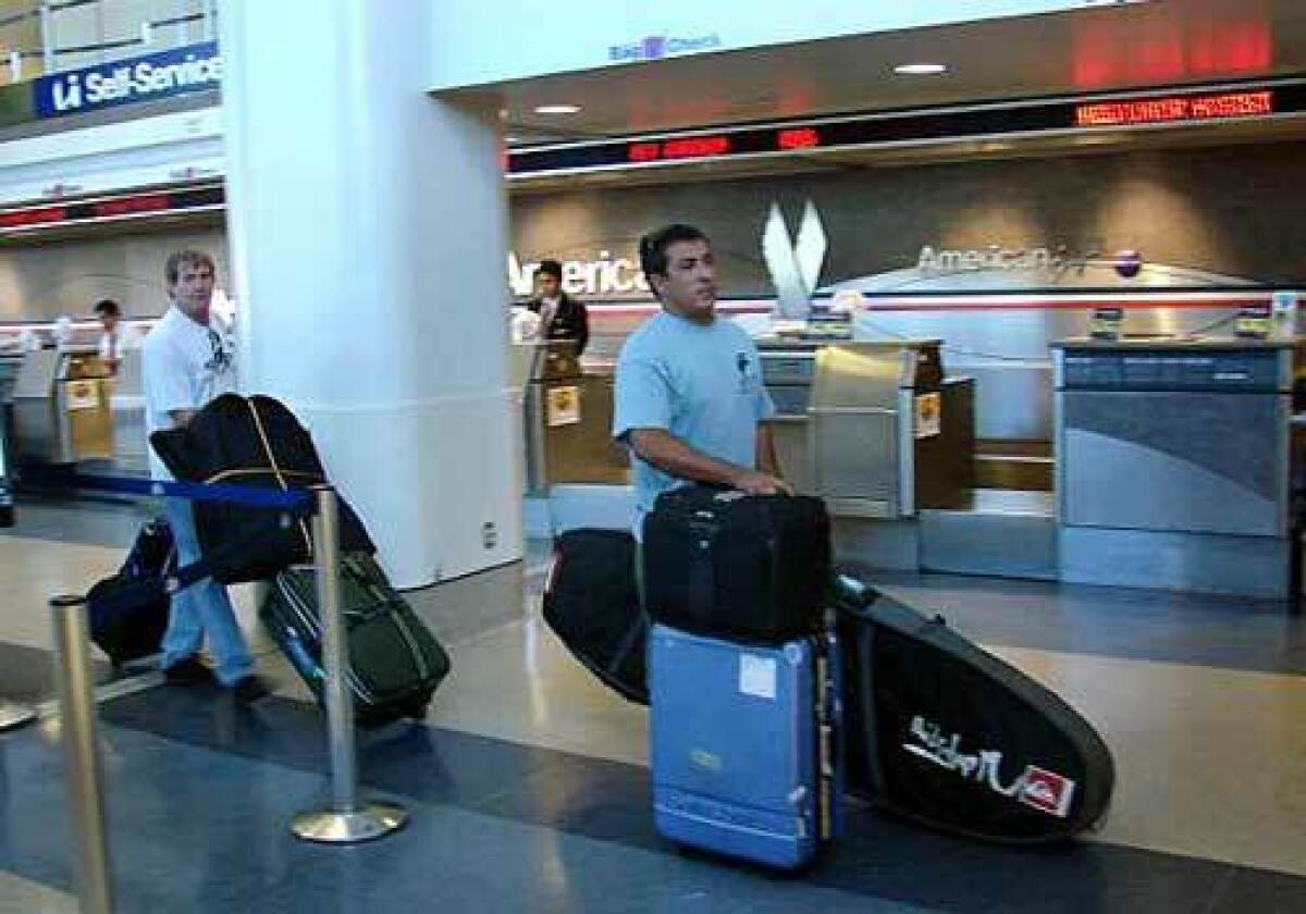 Surfboard maker Danny Villasenor, at Los Angeles International Airport, left one of his boards in L.A. to cut his cost of flying home to Hawaii on American Airlines.