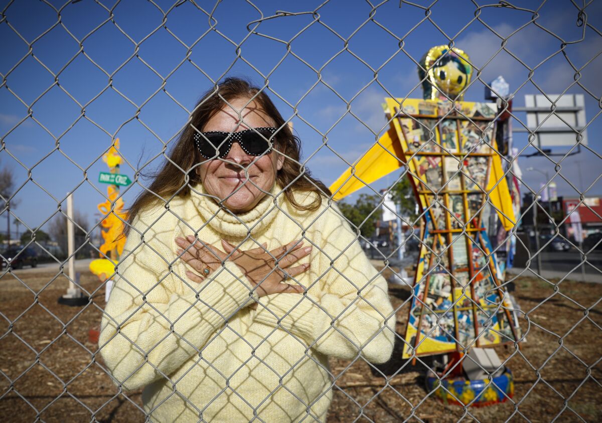 Artist Remigia Bermudez stands near her sculpture titled "I Am" that honors past, present and future relations in her life.