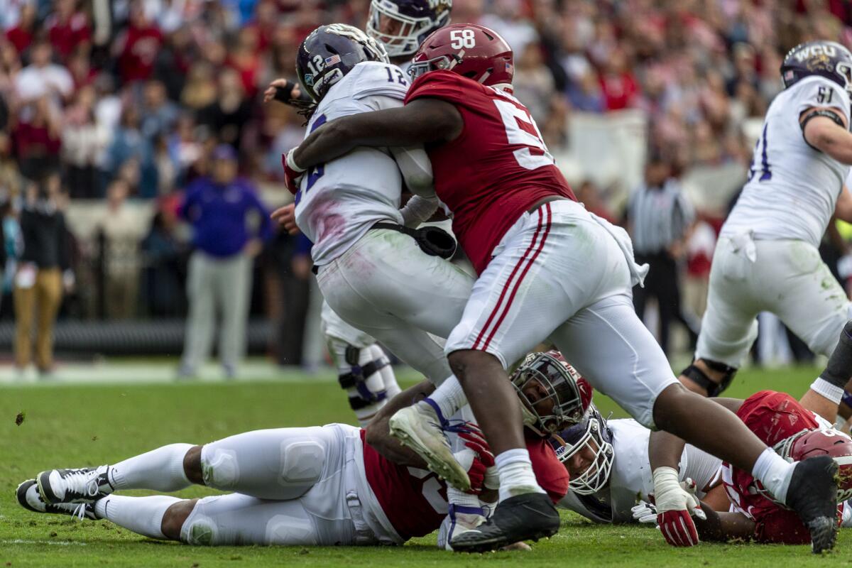 FILE - Alabama defensive lineman Christian Barmore (58) sacks Western Carolina quarterback Tyrie Adams (12) during the first half of an NCAA college football game in Tuscaloosa, Ala., in this Saturday, Nov. 23, 2019, file photo. Barmore is rated as the draft's best tackle among a weak group and could be gone unless the Browns move to get him. (AP Photo/Vasha Hunt, File)