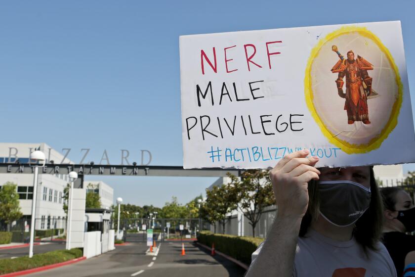 Employee holds sign up during walkout to protest the reported sexual harassment and discrimination at Activision Blizzard, in Irvine on Wednesday, July 28, 2021. An organizer who did not want to give her name said that the walkout was "in solidarity with the victims who have stood up, who have made their voices heard. And we are looking to amplify those voices as well as to create a call to action on the demands that we listed." The company statement sent via email to this reporter by employee Christy Um said OWe are fully committed to fostering a safe, inclusive and rewarding environment for all of our employees around the world. We support their right to express their opinions and concerns in a safe and respectful manner, without fear of retaliation. The company does not retaliate for any such decision, should employees choose to participate or not. The company will not require employees to take time off to participate in this walkout.O The walkout began at 10am and continued until 2 pm. Nofurther actions were planned, according to walkout representatives.