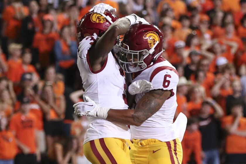 USC receiver Jordan Addison celebrates his touchdown catch by jumping in the air with running back Austin Jones