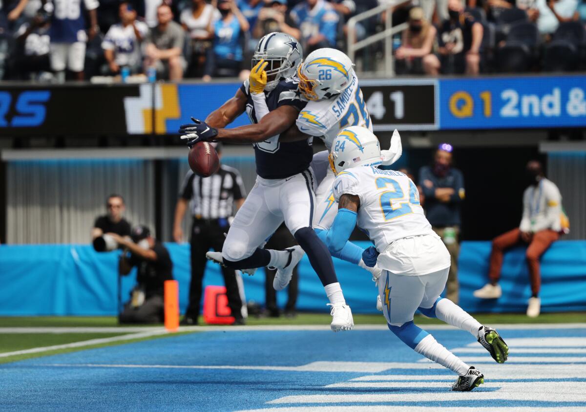  Chargers' Asante Samuel Jr.  breaks up a pass intended for Cowboys receiver Amari Cooper (19) in the end zone.
