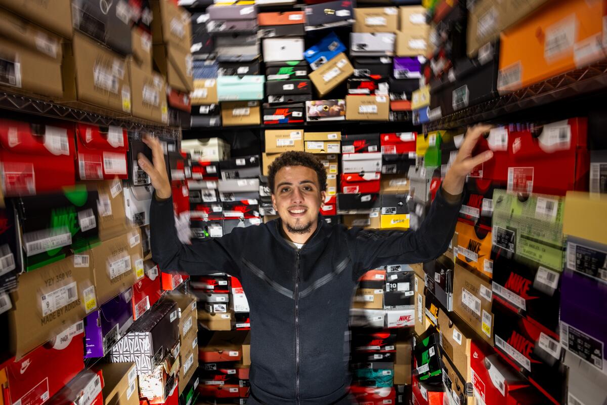 Rami Almordaah, a shoe buyer at Cool Kicks on Melrose Avenue, poses for a portrait in the store room.