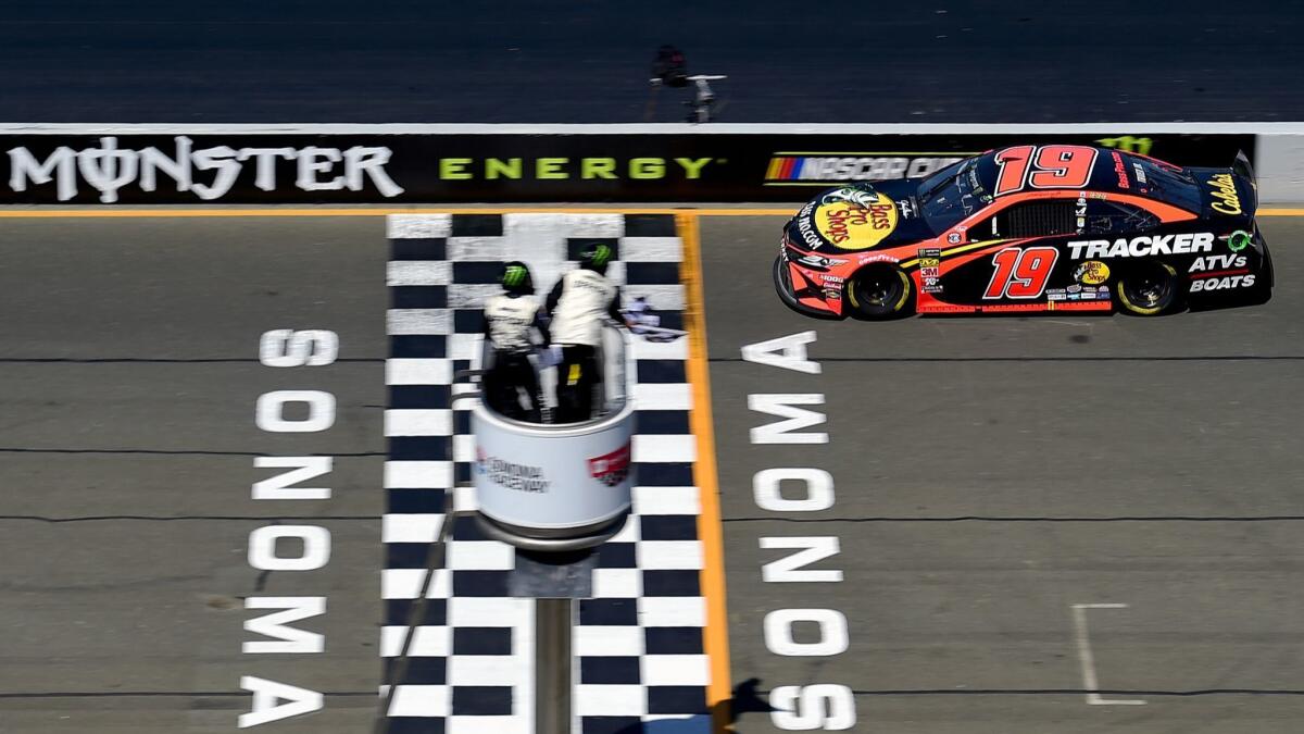 Martin Truex Jr. crosses the finish line to win Sunday's NASCAR Cup race at Sonoma Raceway.