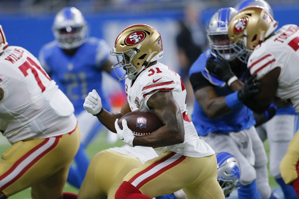 San Francisco 49ers running back Raheem Mostert runs against the Detroit Lions in the first half of an NFL football game in Detroit, Sunday, Sept. 12, 2021. Mostert will undergo season-ending surgery on his knee after getting injured in the season opener Sunday, (AP Photo/Duane Burleson)