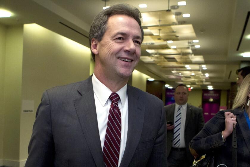 FILE -In this Feb. 23, 2019, file photo, Montana Gov. Steve Bullock walks to a meeting during the National Governors Association 2019 winter meeting in Washington. (AP Photo/Jose Luis Magana, File)