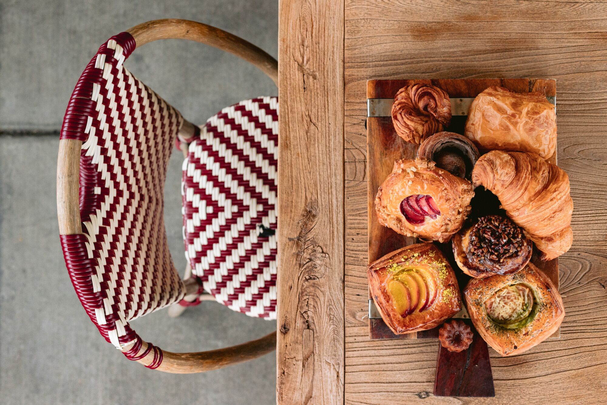 Top down view of a tray of pastries sitting on a cutting board on a table.