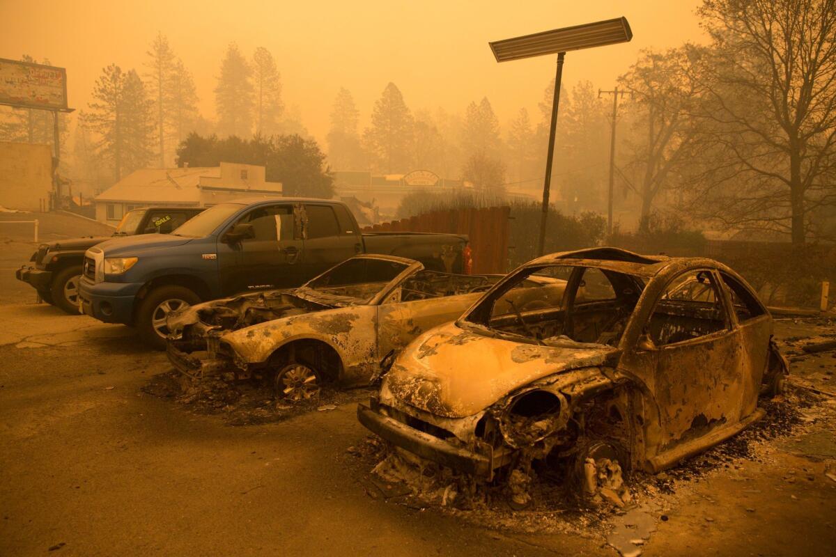 Cars sit among one of the many commercial businesses destroyed in Paradise by the Camp fire.