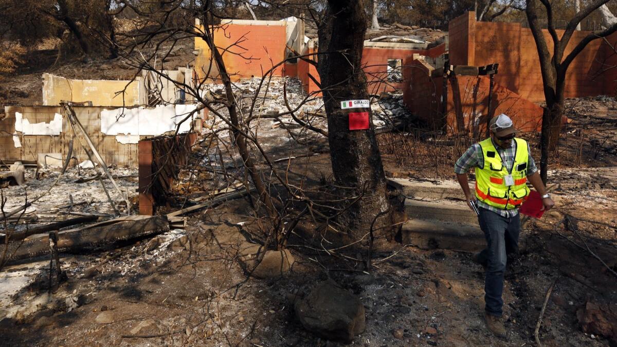 Patrick Ryan, engineering manager with the Napa County planning department, red tags a home destroyed in the Atlas fire in 2017. The survey found that the metropolitan area of Napa had one of the lowest poverty rates in the U.S., at 8.2%