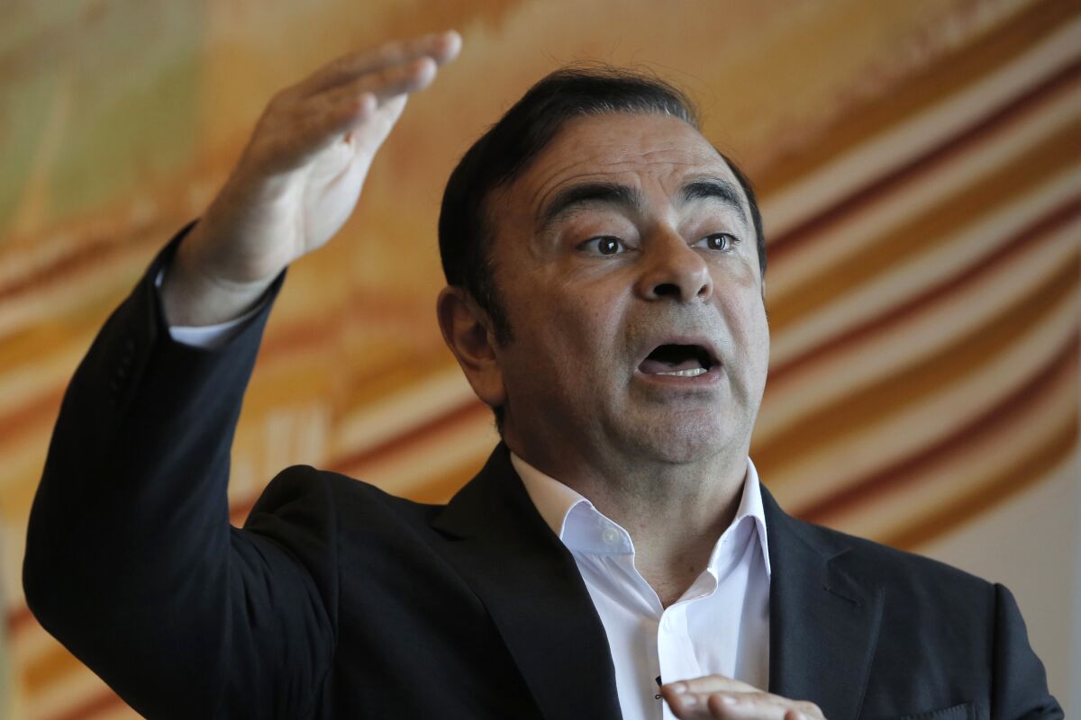 FILE - In this Friday, April 20, 2018, file photo, Nissan Chairman Carlos Ghosn speaks during an interview in Hong Kong. The criminal trial against Japanese automaker Nissan and its former executive Greg Kelly will open in Tokyo District Court on Sept. 15. It’s the latest chapter in the unfolding scandal of Carlos Ghosn, a superstar at Nissan Motor Co. until he and Kelly were arrested in late 2018. (AP Photo/Kin Cheung, File)