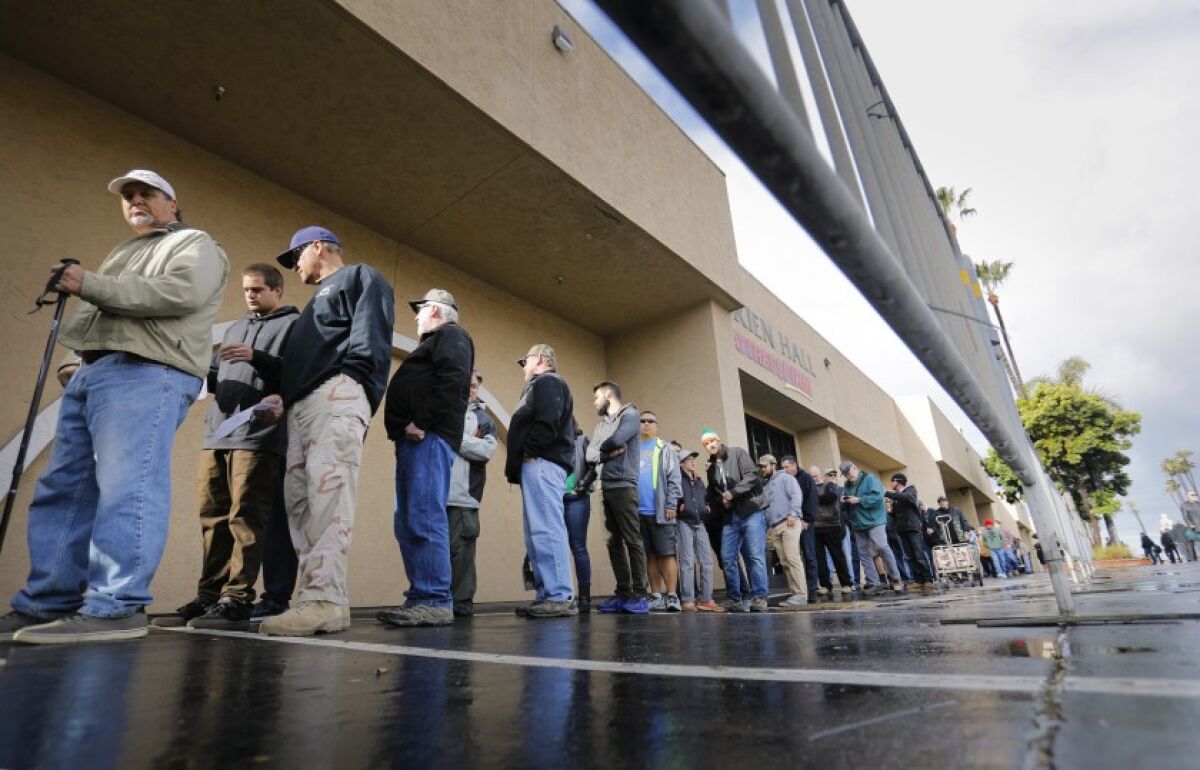 People line up to enter a Crossroads West Gun Show in 2018 at the Del Mar Fairgrounds.