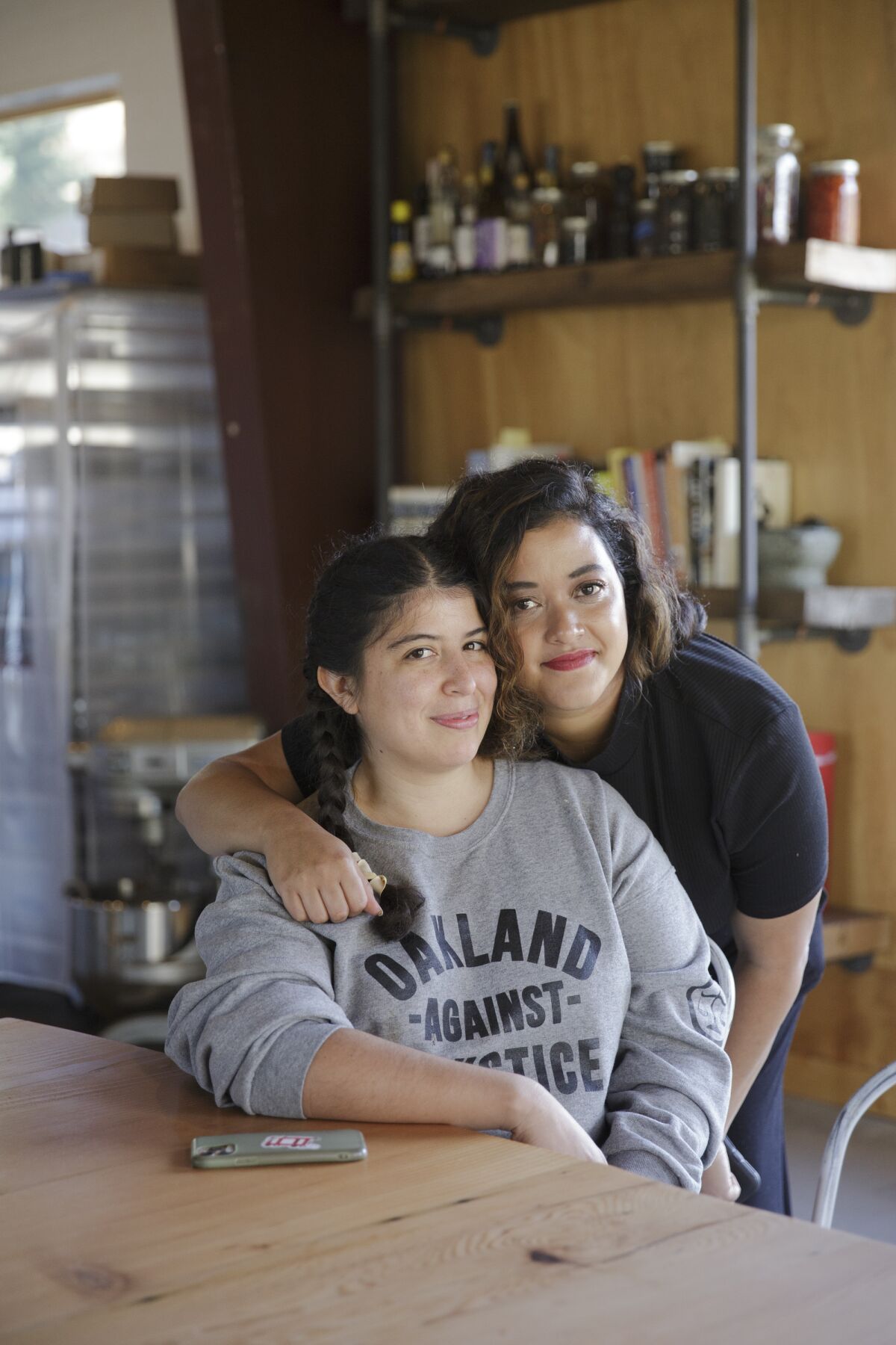 Jirka Jireh, right, hugs friend Yakira Batres at Hiyu Wine Farm in Hood River, Ore.