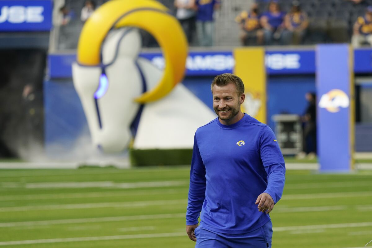 Los Angeles Rams head coach Sean McVay smiles as he walks on the field during NFL football camp Thursday, June 10, 2021, in Inglewood, Calif. (AP Photo/Marcio Jose Sanchez)