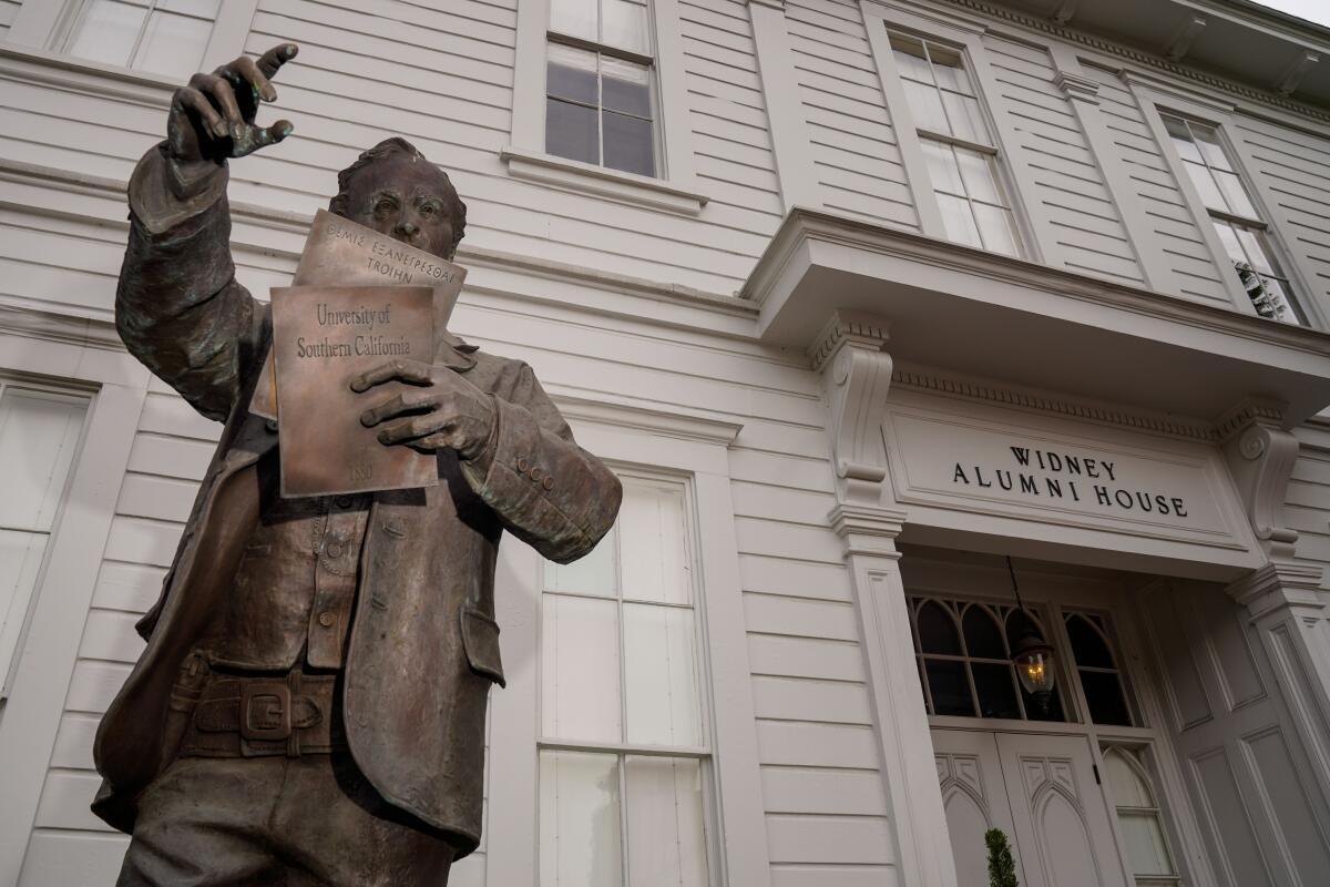 A statue of Judge Robert Widney stands in front of the Widney Alumni House