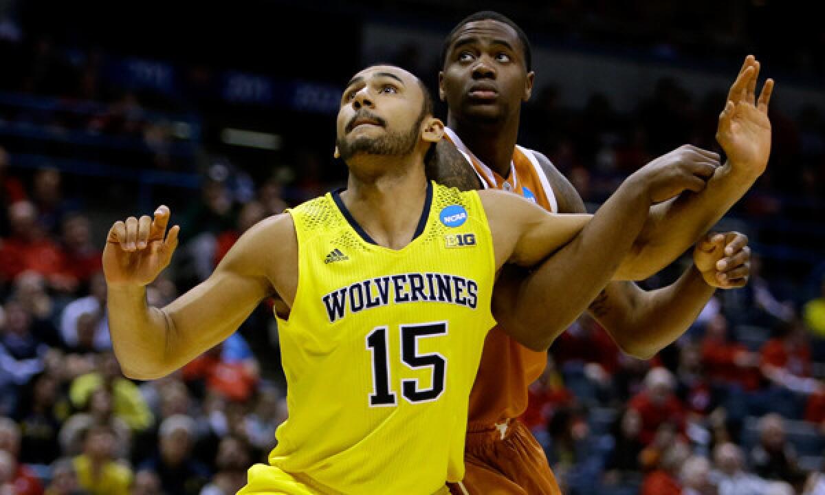 Michigan's Jon Horford, left, boxes out Texas' Prince Ibeh during the Wolverines' win in the third round of the NCAA tournament on Saturday.
