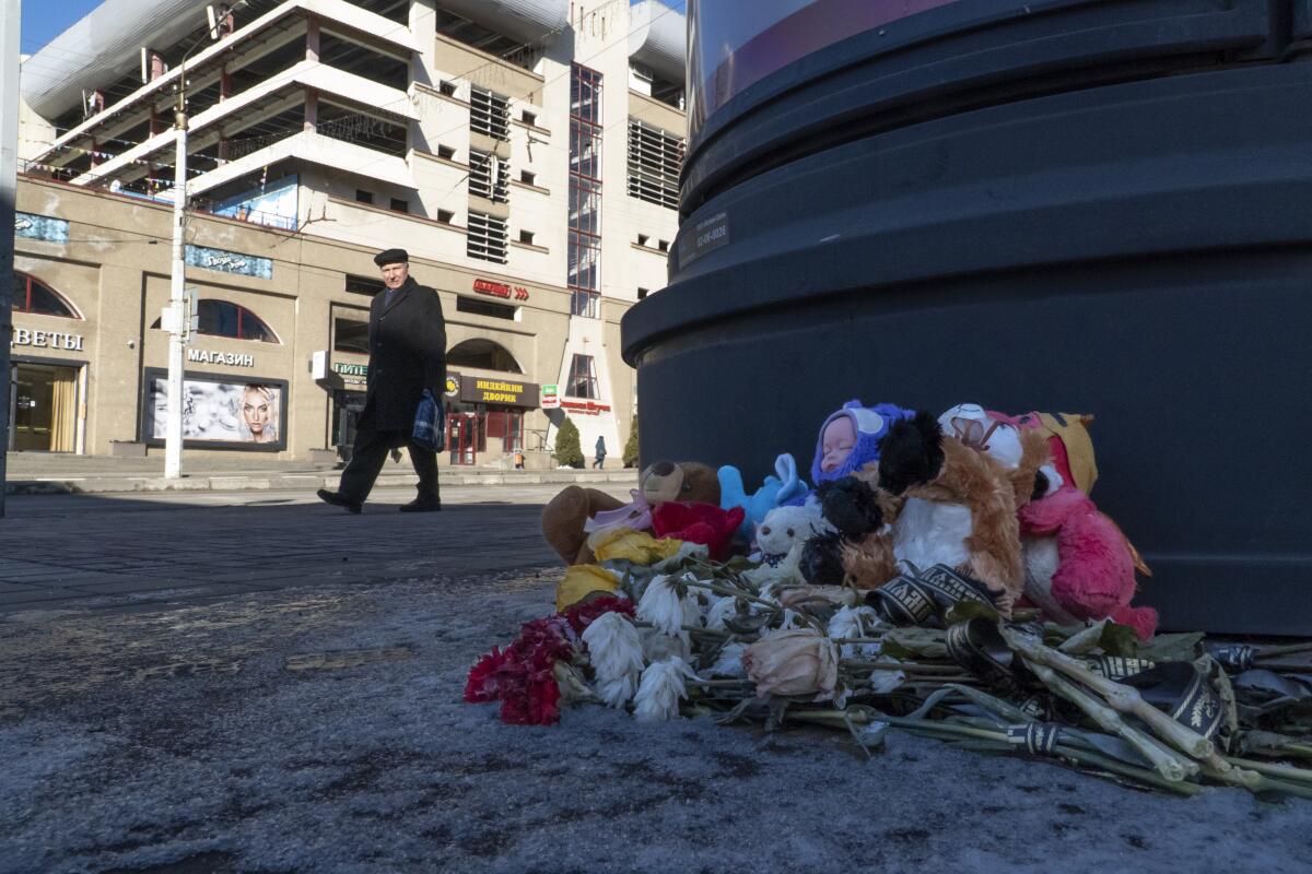 Flowers and toys lie on the ground at a makeshift memorial commemorating victims of a Dec. 30 missile attack.
