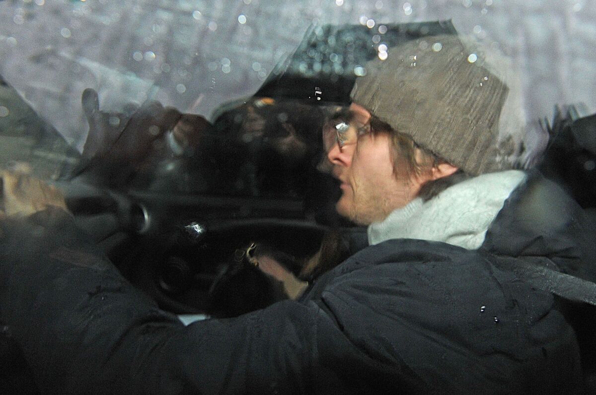 Amanda Knox's ex-boyfriend, Raffaele Sollecito, leaves police headquarters in the Italian city of Udine on Friday. A court in Florence ordered Sollecito to turn in his passport.