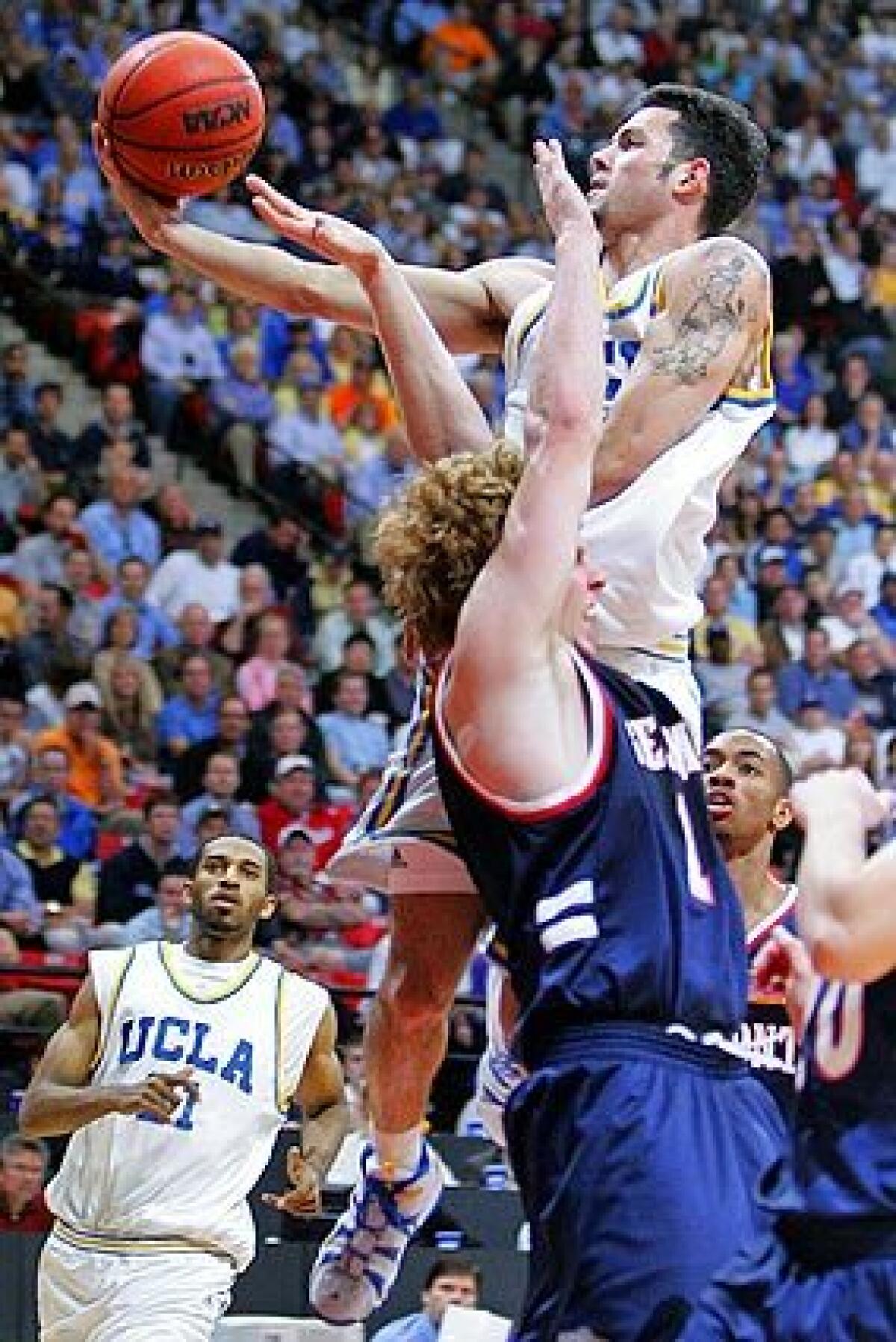 Jordan Farmar cuts through the defense of the Belmont Bruins forward Brian Collins for two points.