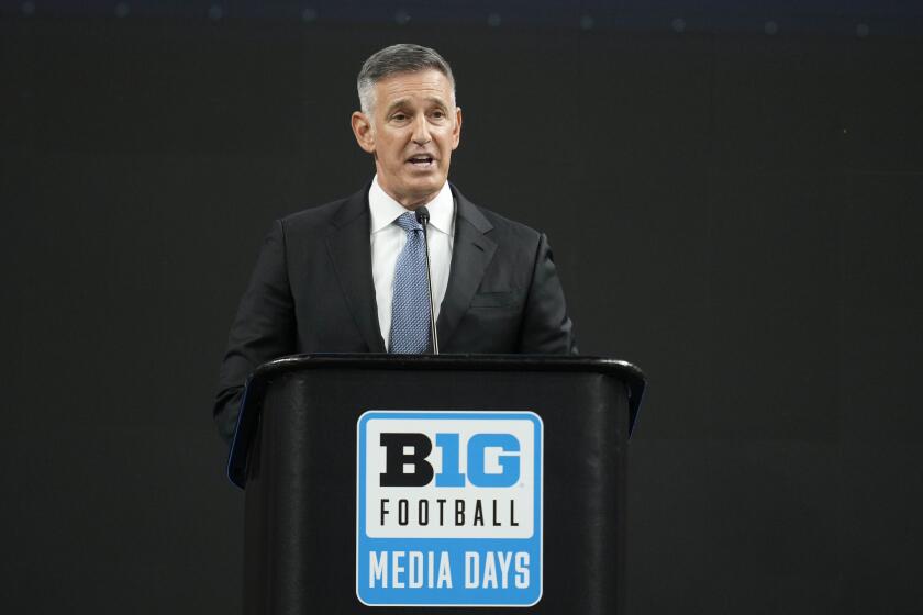 Big Ten Commissioner Tony Petitti stands at a podium and speaks during a Big Ten Conference media days news conference